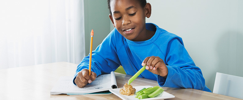 Child eating healthy snack at home.
