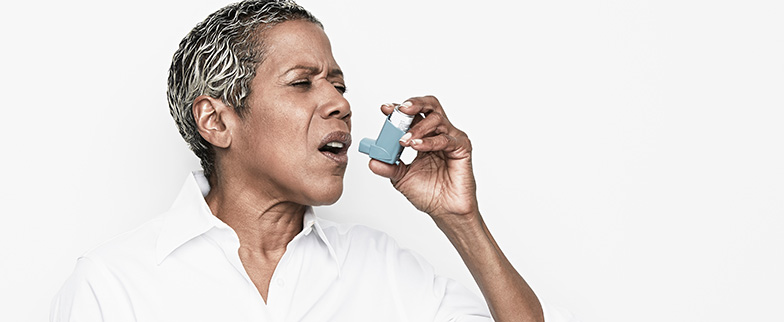 Person learning to use inhaler for asthma.
